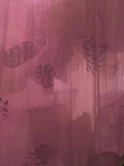 A visitor experiences the 'Cardinal' installation with headphones, immersing themselves in its sensory world. The dreamlike environment of translucent textiles and dynamic light is designed to evoke a deeper range of emotions and introspection.