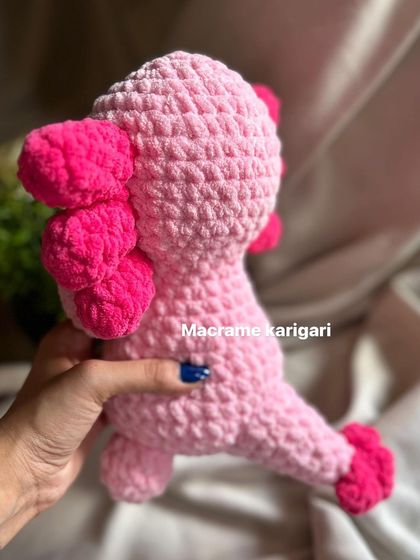 The back view of our crochet axolotl, showing its cute tail and gills. We pay attention to every detail to bring these characters to life.
