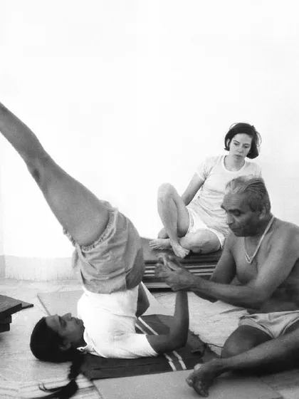 B.K.S. Iyengar teaching his daughter, Geetaji. This image captures the essence of the guru-shishya parampara, the sacred transmission of knowledge from teacher to disciple.