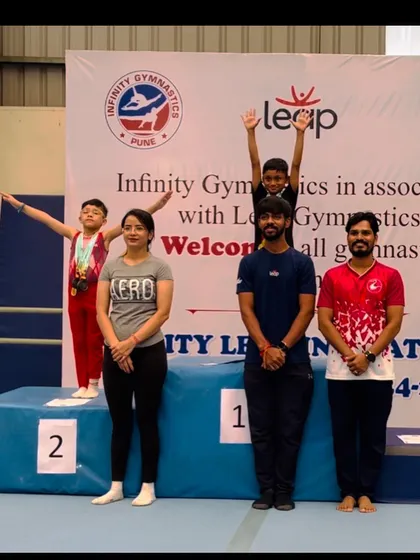 Our coaches stand proudly with our champion on the podium. Their expertise and support are vital to our students' success.