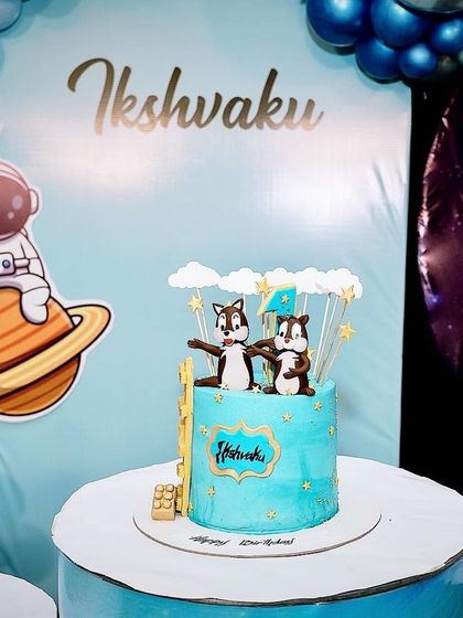 Even the cake table is part of the theme. Here, the space-themed cake is displayed against the galaxy backdrop, next to an astronaut prop, making it a perfect photo moment.
