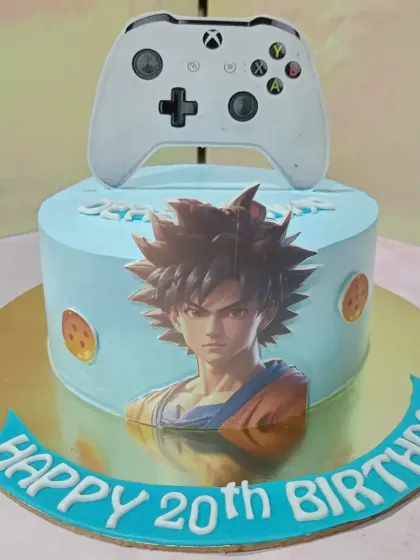 A cake for a Dragon Ball Z fan. This design features a powerful image of Goku and a controller topper, perfect for a gamer's 20th birthday.