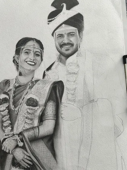 This image shows the wedding portrait clipped to my drawing board. The bride is complete, and I am beginning to add the initial shading to the groom's portrait.