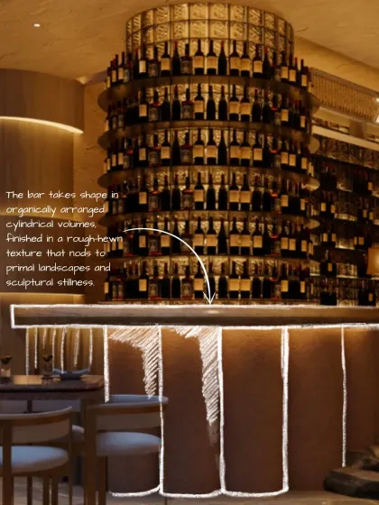 The bar at Zuvaah takes shape in organically arranged cylindrical volumes. The rough-hewn texture nods to primal landscapes and sculptural stillness, anchoring the space with an earthy, powerful presence.