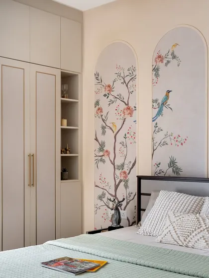 I believe in adding soulful, personal touches to every project. In this bedroom, hand-painted murals of birds and blossoms within arched panels create a unique, artistic focal point, complemented by custom muted cabinetry for a tranquil and elegant retreat.