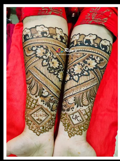 The back of the arms for this bridal design, featuring elephants and the wedding date.