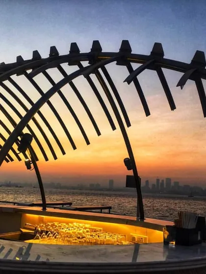 A close-up of the sculptural bar canopy on the Queensline Sea Yah against the sunset. This element was custom designed and fabricated to serve as the centerpiece of the upper deck, creating a memorable visual landmark for guests.