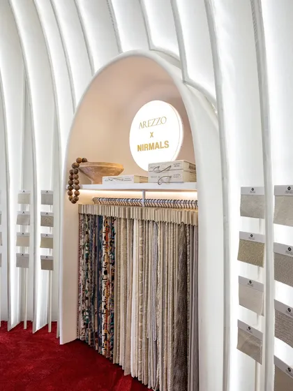 Here, you can see the beautiful fabric samples hanging within a custom-designed arched niche. The soft lighting from above highlights the textures and colors, making the product the hero within the space.