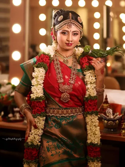 An authentic Iyengar bridal look, complete with the traditional nine-yard saree and temple jewelry. The parrot prop adds a classic, symbolic touch.