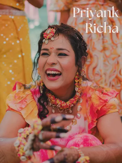 The bride's infectious laugh during her tie-dye themed Haldi ceremony. It's a moment of pure, unadulterated joy that perfectly captures the spirit of the day.