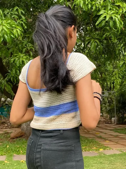 A side view of the cap sleeve top, highlighting the short, slightly puffed sleeves that add a touch of Y2K and soft girl aesthetic.