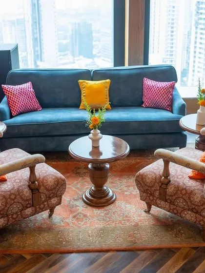 A comfortable lounge area at the Mehendi, with a stunning view of the city skyline. We used colorful cushions to add a pop of festivity to the elegant furniture, blending comfort with celebration.