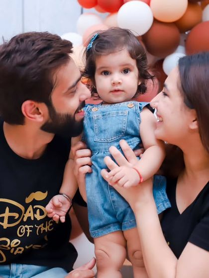 A candid moment of love and interaction during a family photoshoot. These natural moments make for the most cherished memories.