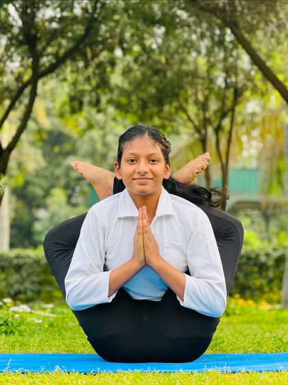 Balance is something you create. This young student finds her center in this beautiful and complex seated balancing pose.