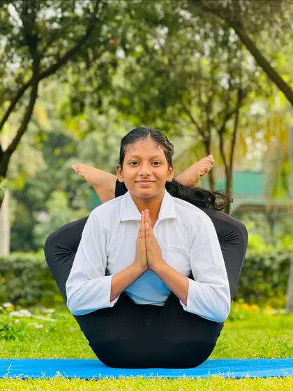 Balance is something you create. This young student finds her center in this beautiful and complex seated balancing pose.
