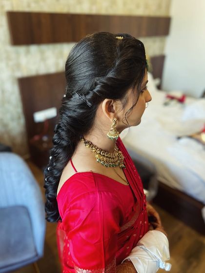 A side view of a thick, textured braid for a Gujarati bride. The volume and detail in the braid make it a standout feature.