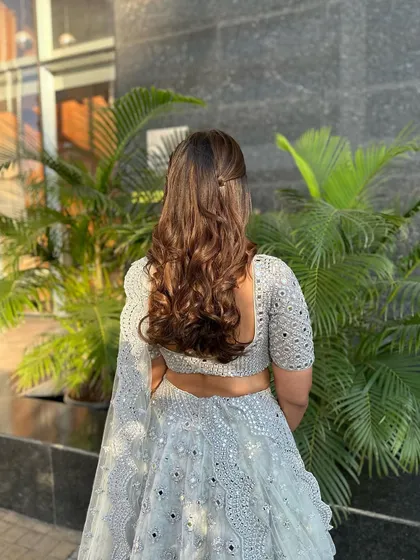 The back view of the simple twisted half-updo, showing how it enhances the soft waves.