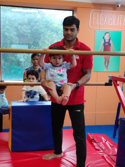 Even our youngest members get to experience the thrill of hanging on the bars. This activity helps build strength and a sense of accomplishment.