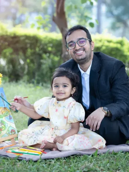 A sweet father-daughter moment, creating a painting together on a picnic blanket in a park. My sessions are about making memories, not just posing for them.