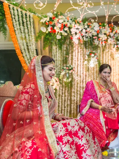 A candid moment of laughter and joy, showing the bride sharing a lighthearted moment with her mother during the wedding festivities.