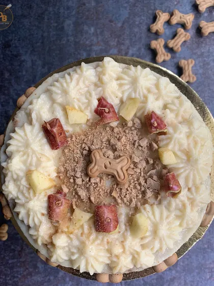 A top-down view of this delicious dog cake, showing off all the yummy toppings. I use fresh apples, a sprinkle of carob powder, and creamy frosting to make every bite exciting for your furry friend.
