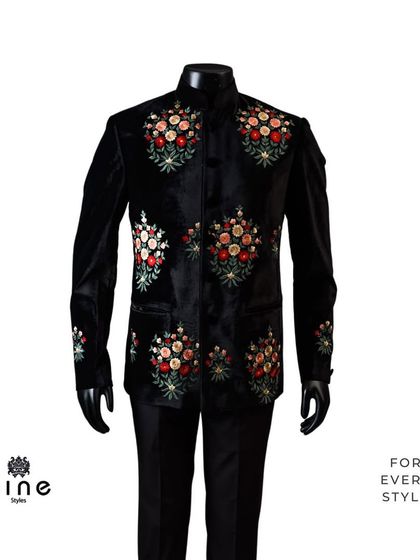 A black velvet bandhgala adorned with colorful floral bouquets. This piece combines the formality of a bandhgala with the vibrant beauty of hand embroidery.