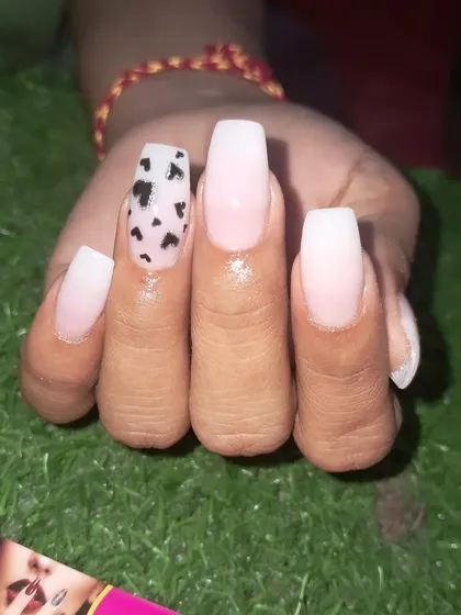 A close-up of the black hearts accent nail on this coffin-shaped set.