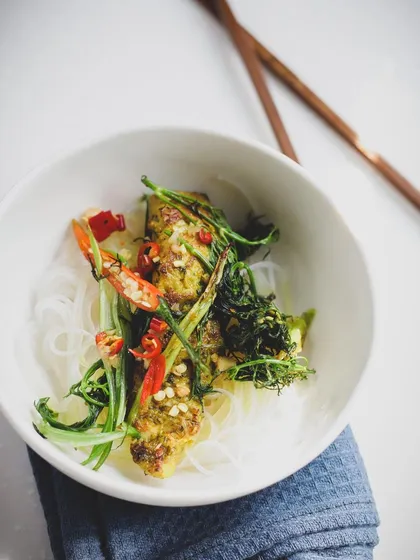 A beautifully plated Asian noodle dish, showcasing the balance of colors, textures, and flavors that is central to the cuisine.