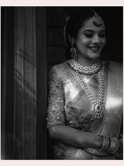 A timeless black and white portrait of the bride. The soft lighting and her gentle smile create a classic and elegant image.