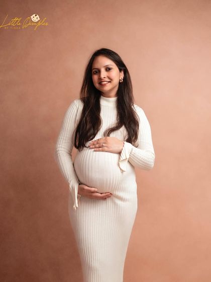 A beautiful solo portrait in a simple white ribbed dress. The soft, neutral background creates a warm and timeless feel.