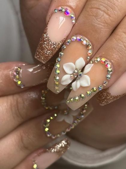 This set is all about the bling, with coffin-shaped nails featuring gold glitter, 3D flowers, and a full border of iridescent rhinestones.