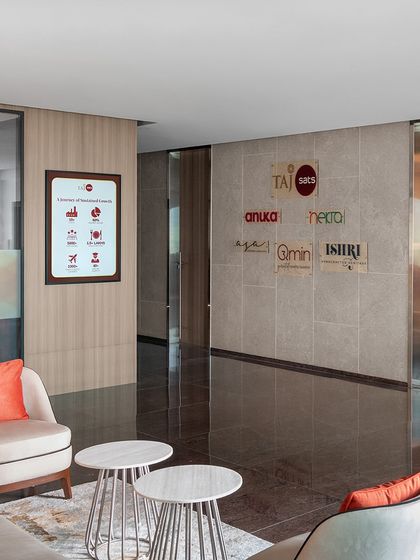 The double-height entrance lobby of 'The High-Flying Office' was completely transformed with new granite flooring. The existing staircase was enhanced with feature lighting to create a more dramatic arrival sequence.