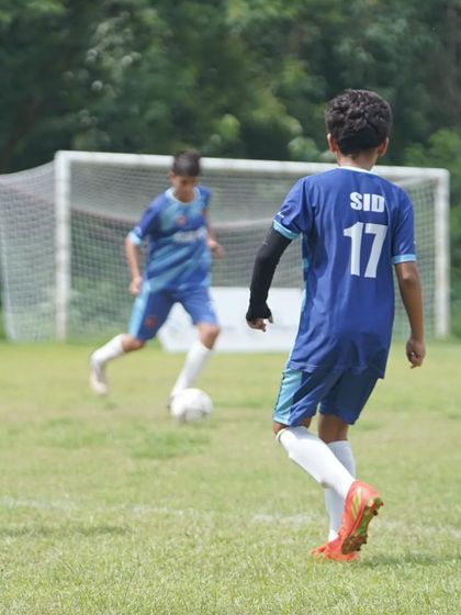 Sidhaan in possession, looking to create an opportunity for his team. His focus and determination are clear.