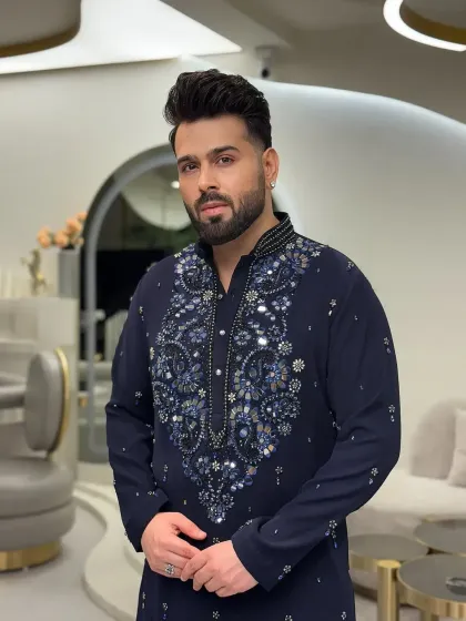 A portrait of the client in the navy blue embellished kurta.