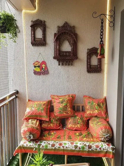 I love bringing different themes to life. This balcony was inspired by the vibrant culture of Rajasthan, using traditional block-print textiles for the seating, paired with carved wooden jharokhas on the wall to create an ethnic and colourful retreat.