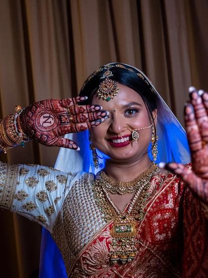 Shining hands for a shining bride. My beautiful bride Jahnavi, playfully showing off her mehendi, which features her and her partner's initials.