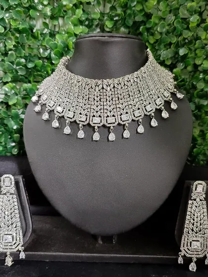 This American Diamond set features a wide, intricate choker and long, dramatic earrings, designed to make a bold statement at any evening event.