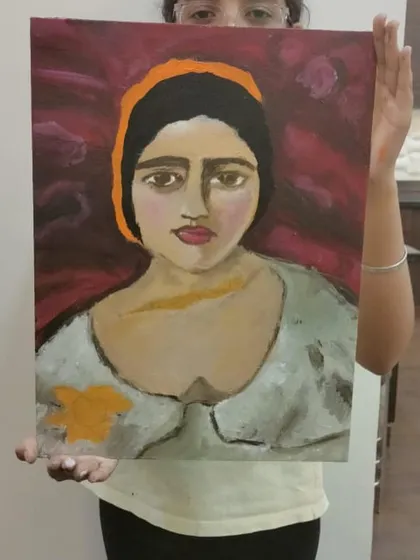 A close up of a finished Amrita Sher-Gil inspired portrait, showcasing the student's brushwork and color choices.