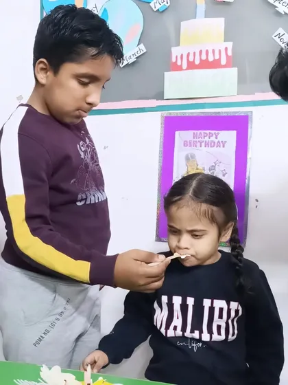 A sweet moment of friendship as one child shares a bite of cake with another. These are the social connections we work to foster every day.