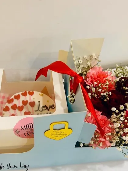I love creating hampers that combine the best of both worlds. This Valentine's Day gift box features a mini heart-themed cake alongside a fresh bouquet of carnations, making it a complete and heartfelt surprise for your special someone.
