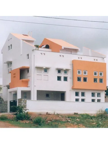 A full view of the 'Nachiar Illam' residence, highlighting how the split-level design accommodates both pedestrian and vehicle access on different planes.