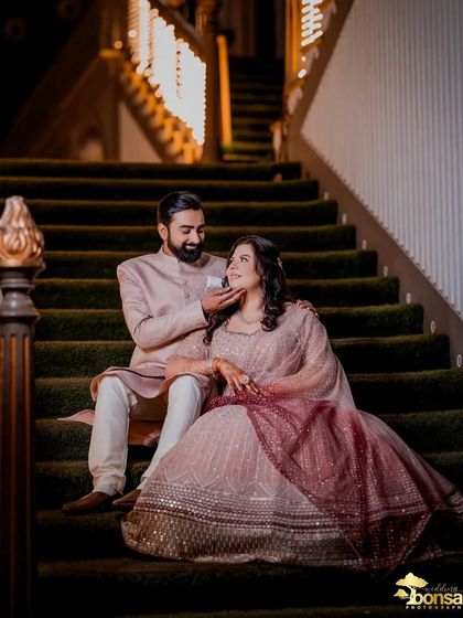 A candid moment on the stairs during their Roka ceremony. This shot shows their comfortable and loving relationship, beautifully documented.
