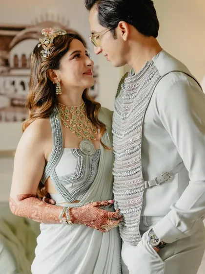 Lost in each other's eyes. A close-up portrait of the couple, their modern, coordinated outfits looking chic and elegant.