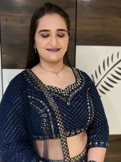 A chic and modern look for a younger guest. The navy blue lehenga is paired with a cool-toned smokey eye and a simple, sleek hairstyle.
