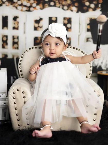 Holding a makeup brush, this little fashionista is in her element. We use fun props to make the theme interactive.