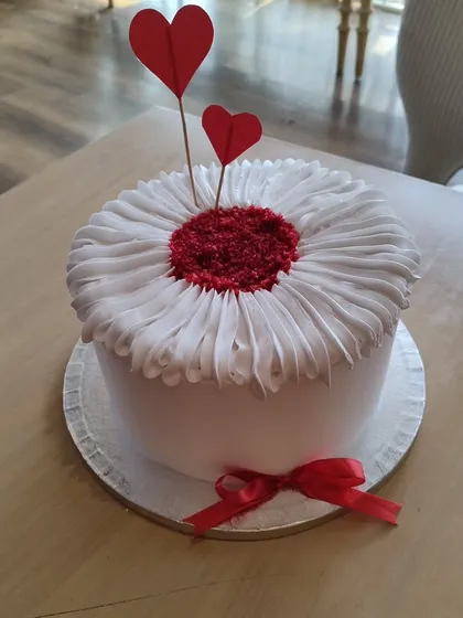 The lovely cake for the 10th-anniversary celebration. I help coordinate key moments like the cake cutting to make them special and seamless.