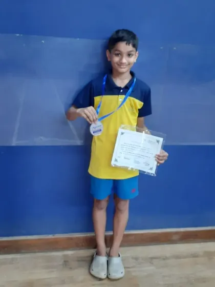 Another shot of Liam Pais proudly displaying his silver medal and certificate.