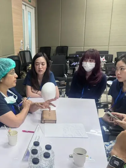 A small group discussion and demonstration during the hands-on portion of the workshop. This allows for personalized feedback.