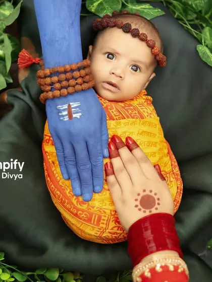 A divine blessing. This conceptual newborn portrait represents the protection of Lord Shiva and Parvati over a precious new life. It's a powerful and artistic way to celebrate a baby born during the holy month of Saavan.