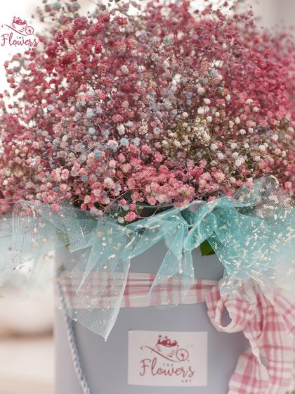 A closer look at the colorful gypsophila bouquet. The mix of pink and blue hues creates a whimsical, cotton-candy effect, perfect for a lighthearted and joyful occasion.